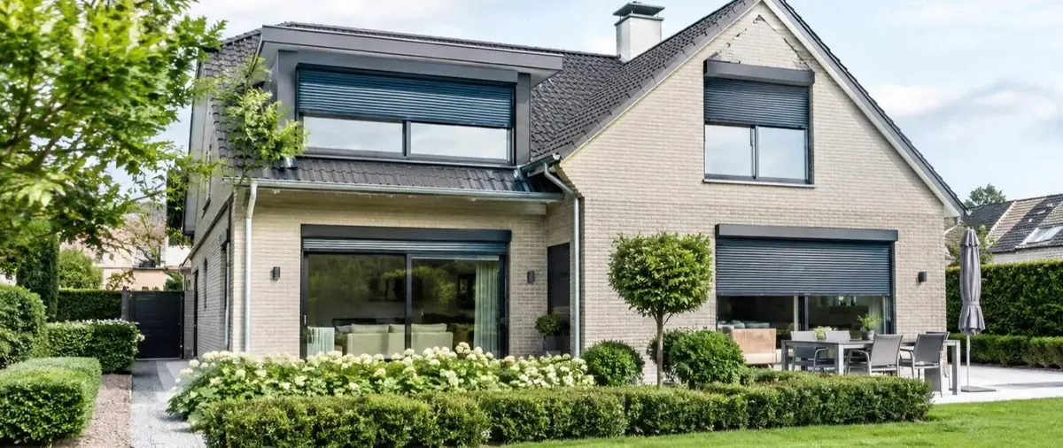 Maison moderne en briques claires équipée de volets roulants